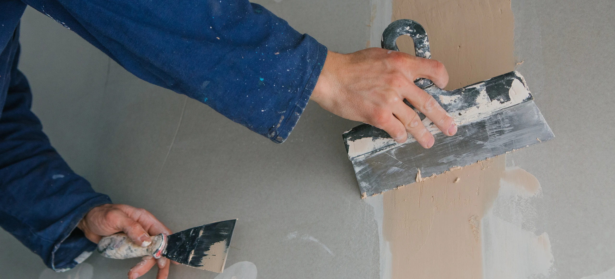 Close-up of drywall crack repair using joint compound in Bellevue, WA