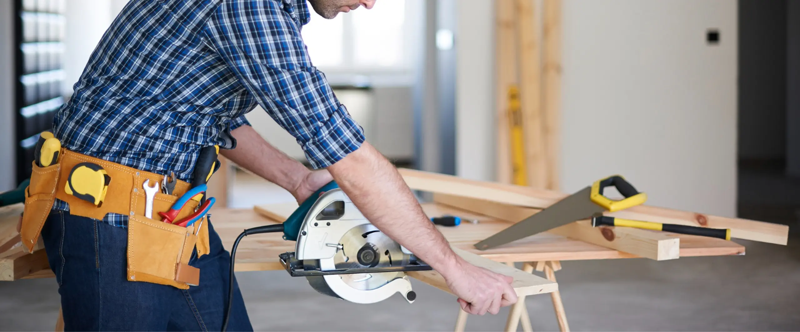 Commercial carpenter cutting timber with a circular saw in Redmond